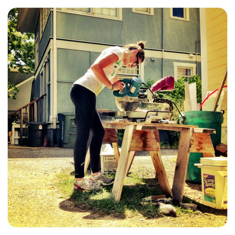 K uses power tools like a boss to trim the wood planks that line the aft cabin.